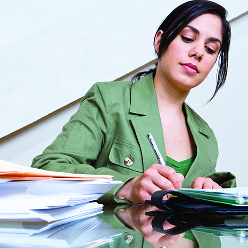 Businesswoman filling out paperwork 