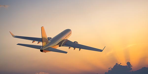 Aeroplane taking off into sunset