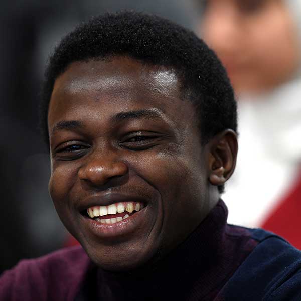 Student smiling in classrooom.